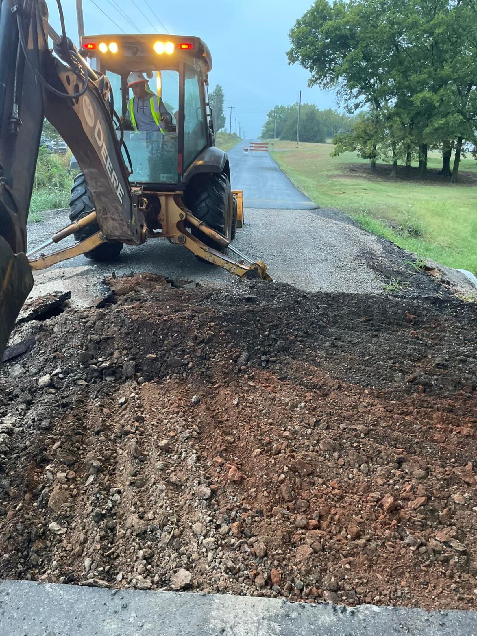 Asphalt road repair backhoe