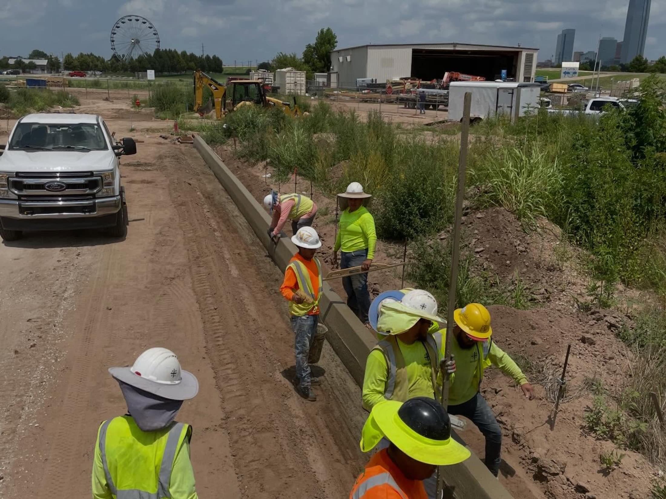First Water curb crew with the Oklahoma City skyline behind them