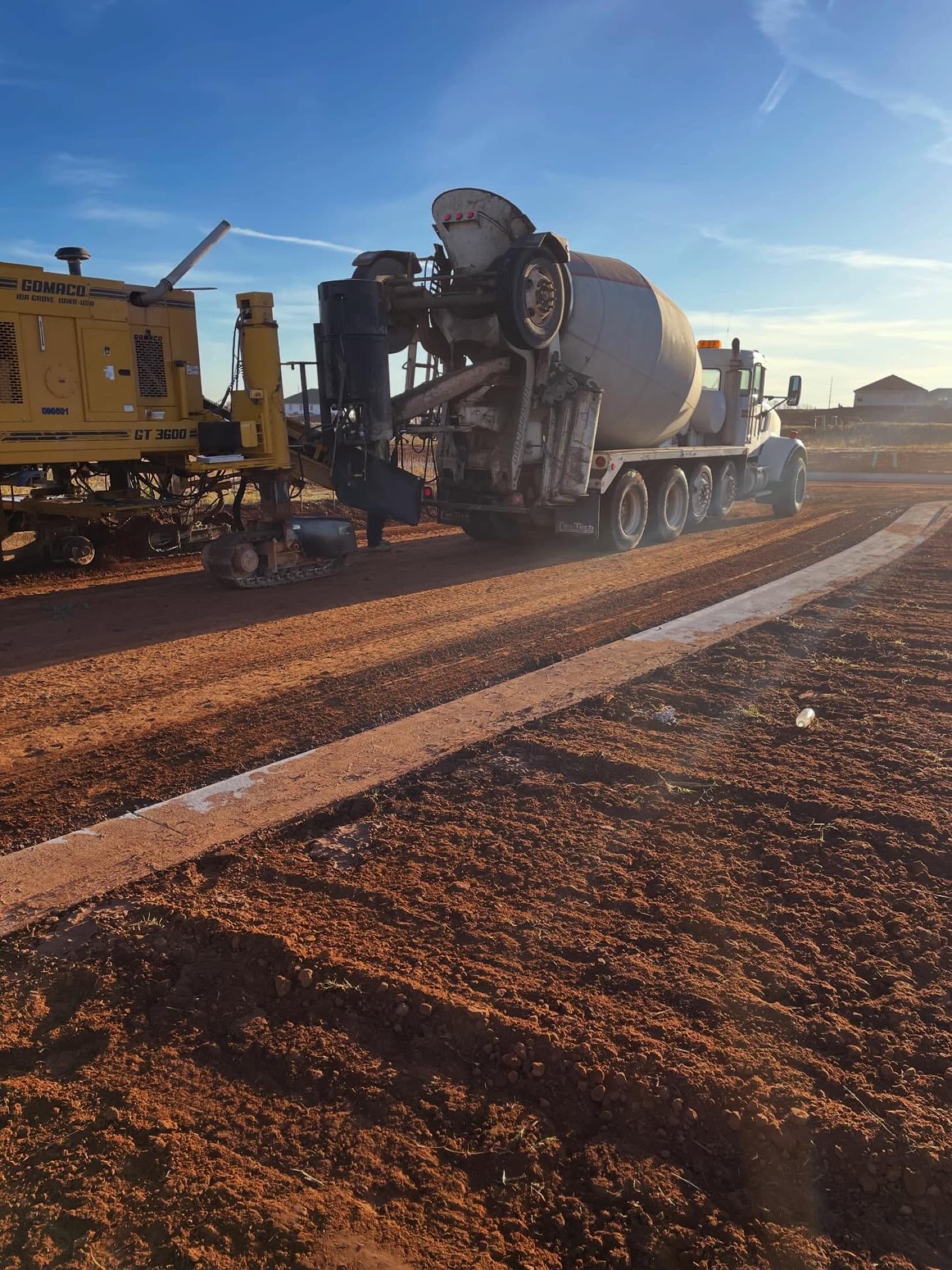 Concrete slipform paving at sunrise